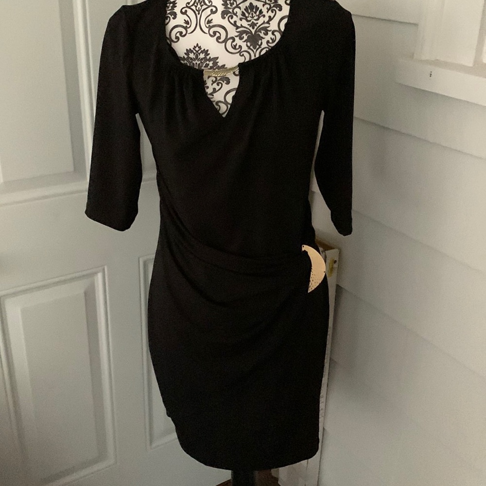 Black dress with ornament detail at the front and on the hip
